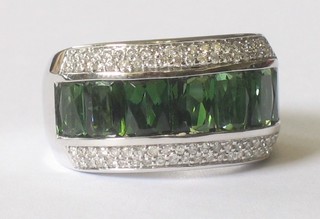 A 14ct white gold dress ring set baguette cut tourmalines supported by diamonds