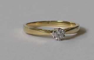 An 18ct yellow gold dress ring set a solitaire diamond