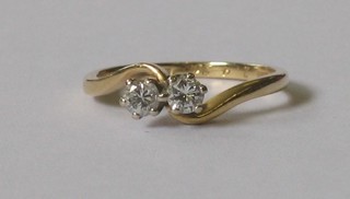 An 18ct gold cross over dress ring set 2 diamonds approx 0.30ct