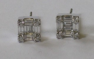 A pair of square cut diamond ear studs approx 