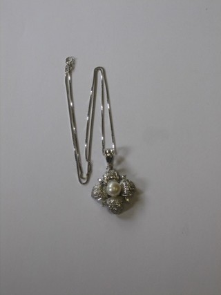 An 18ct white gold diamond set pendant hung on a fine gold chain