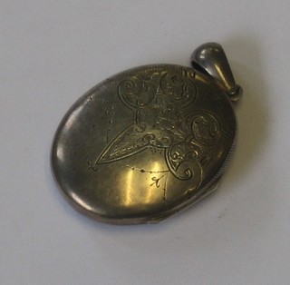 An oval engraved silver locket