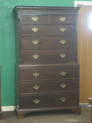 A Georgian oak chest on chest with moulded cornice, the upper section fitted 2 short drawers above 3 long drawers, the base fitted 3 long drawers with brass swan neck handles, raised on bracket feet 42"