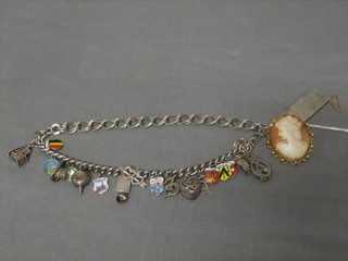 A silver ingot pendant, a charm bracelet hung numerous charms and a cameo brooch