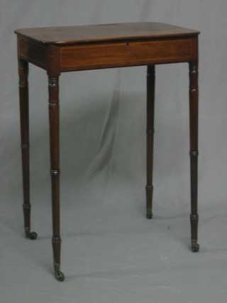 A 19th Century rectangular mahogany table with hinged lid, raised on turned supports ending in brass caps and castors 20"