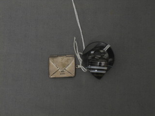 A silver card case in the form of an envelope and a Victorian carved hardstone agate brooch