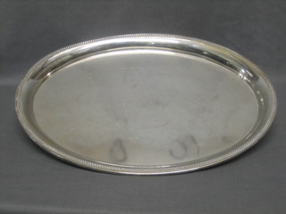 An oval Continental silver tray with bead work border marked 800,