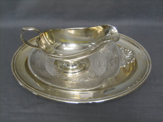 A large silver plated sauce boat, an oval silver plated meat platter and an engraved silver plated dish