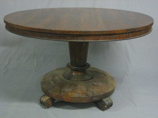 A Victorian circular rosewood snap top breakfast table raised on a chamfered base 48"