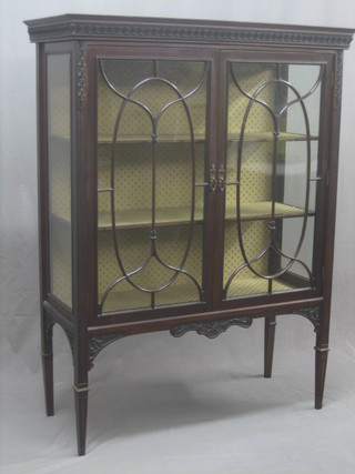A Victorian mahogany display cabinet with moulded cornice, the interior fitted shelves enclosed by astragal glazed panelled doors, raised on square tapering supports 42"