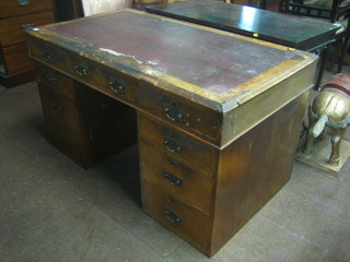 A walnut kneehole pedestal desk with inset tooled writing surface, the frieze fitted 3 long drawers, the pedestals fitted 6 short drawers  53" (requires some attention)