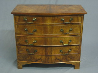 A walnut and crossbanded bow front chest of 4 long drawers raised on bracket feet 30"
