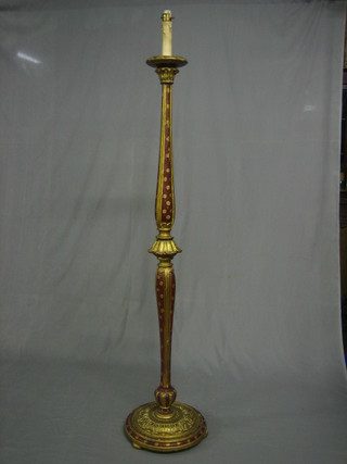 A carved and painted standard lamp (old repair to stem)