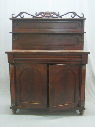 A Victorian mahogany chiffonier, the raised back fitted 2 shelves, the base fitted 1 long drawer above a cupboard enclosed by arch shaped panelled doors, raised on a platform base 42"