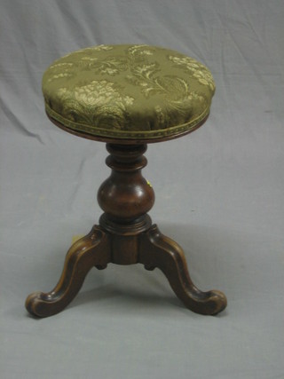 A Victorian mahogany adjustable piano stool raised on pillar and tripod base