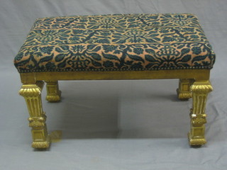 A 19th Century rectangular gilt painted stool with upholstered seat raised on column supports 28"