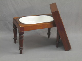 A rectangular mahogany bidet complete with china liner, raised on turned supports 25"