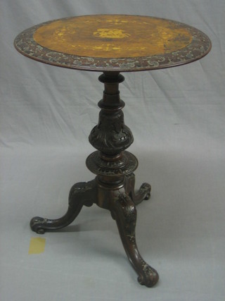 A Victorian circular  carved and figured walnut wine table, theo top inlaid St George slaying the dragon, raised on a carved pillar and tripod base 20"