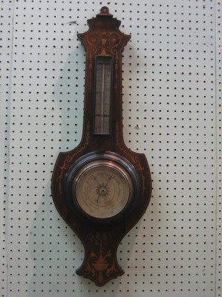 An aneroid barometer and thermometer contained in an inlaid mahogany wheel shaped case