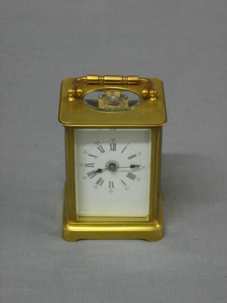 A French 19th Century 8 day carriage clock with enamelled dial and Roman numerals contained in a gilt metal case