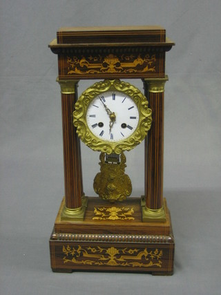 A 19th  Century French 8 day striking quarter carriage clock with enamelled dial and Roman numerals, contained in a gilt metal and inlaid mahogany case supported by columns 16"