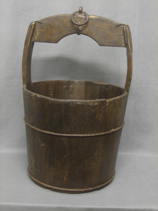 A reproduction wooden and iron banded well bucket