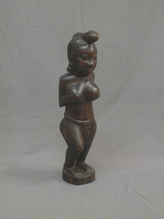 A carved Eastern figure of a native lady clasping her breasts 29"