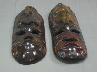 A pair of  oval carved masks decorated with crocodile and turtle 13"