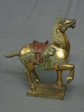 An Eastern carved and gilt painted figure of a horse 13"