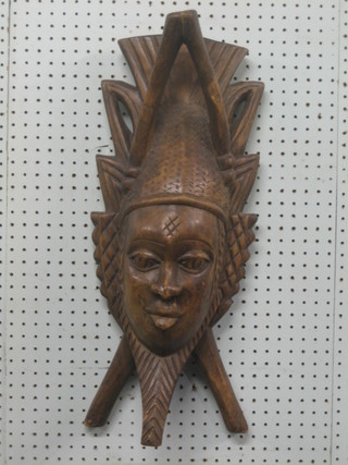 A carved Eastern wall mask 23"