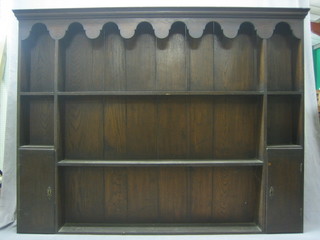 A 19th Century oak dresser back with moulded cornice and wavy apron, fitted 3 shelves flanked by a pair of cupboards 72" 