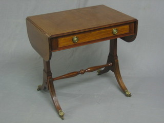 A Georgian style miniature sofa table raised on standard end supports 22"