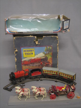 A Hornby clockwork train set comprising train, tender and 2 carriages together with a Corgi 1977 Irish State Coach, boxed
