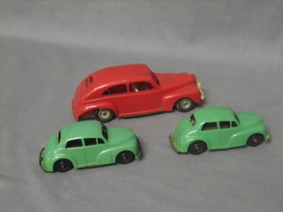 A Minic red plastic car together with 2 other green plastic cars