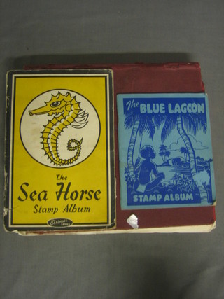 A red album of various stamps together with the Sea Horse album of stamps and a Blue Lagoon album of stamps