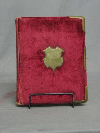 A Victorian fabric covered photograph album containing various black and white photographs