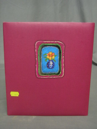 A purple coloured album containing various greetings cards etc