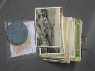 A metal tin containing various postcards