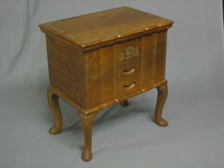 A carved Kashmiri hardwood work table with hinged lid, the base fitted 2 drawers raised on cabriole supports 19"