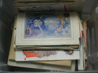 A transparent box containing various programmes etc