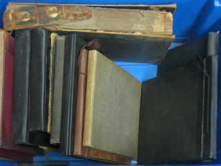 A large blue crate containing 10 various photograph albums
