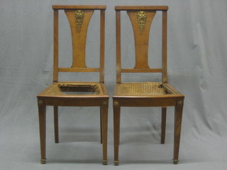 A set of 8 French figured walnut slat back dining chairs with gilt metal mounts and woven rush seats
