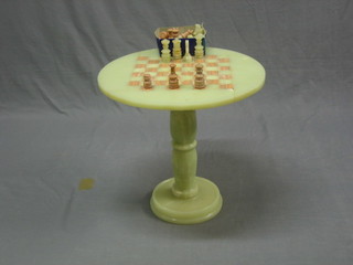 A circular onyx chess table complete with chess set