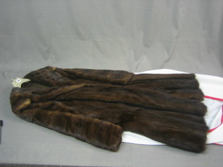 A lady's brown full length fur coat