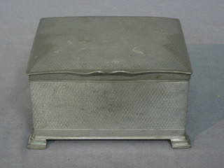 A square English pewter cigarette box with engine turned decoration and hinged lid, raised on bracket feet 4"