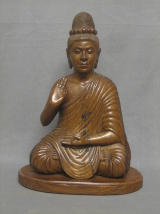 An Eastern carved hardwood figure of a seated Buddha 13"