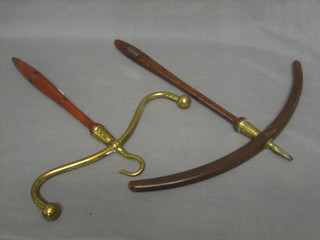 A pair of 19th Century Victorian mahogany and brass coat hangers