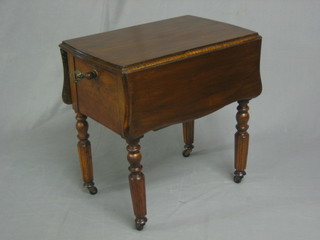 A Victorian walnut and mahogany drop flap work table, fitted a drawer raised on turned and reeded supports 21"