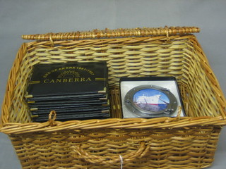 A wicker picnic hamper containing 6 Canberra End of an Era photograph albums and a Canberra photograph frame in the form of a port hole
