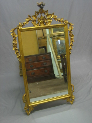 A rectangular plate wall mirror contained in a decorative gilt carved wood frame 44" overall